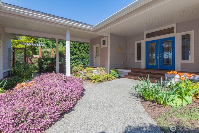 entrance to property featuring covered porch and french doors