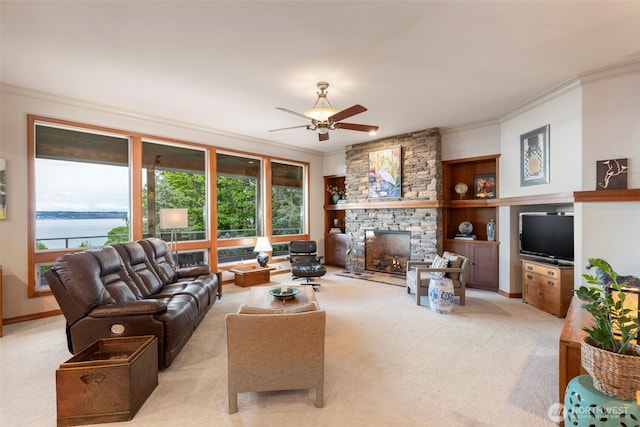 living area featuring crown molding, light colored carpet, and a healthy amount of sunlight