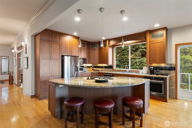 kitchen with backsplash, high end refrigerator, a sink, and wall oven