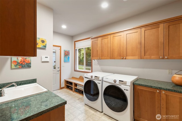 laundry room featuring a sink, cabinet space, light floors, independent washer and dryer, and recessed lighting