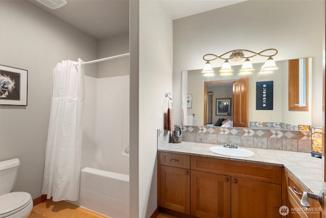 bathroom with vanity, toilet, and shower / tub combo