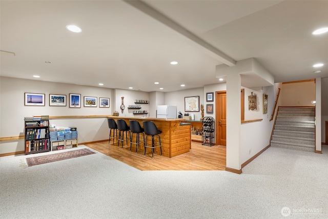 bar with freestanding refrigerator, baseboards, and recessed lighting