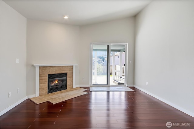 2322 157th Street Ct E, Tacoma, WA 98445 - unfurnished living room featuring baseboards, wood finished floors, and a tiled fireplace