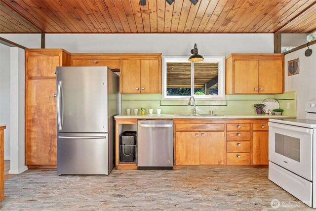 kitchen with appliances with stainless steel finishes, wood ceiling, a sink, light countertops, and light wood-type flooring