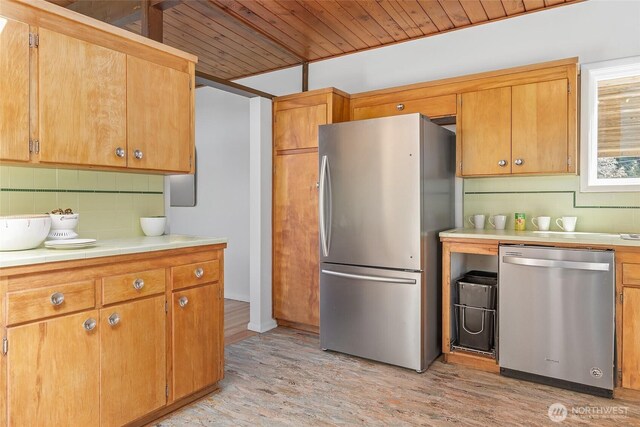 kitchen with stainless steel appliances, wooden ceiling, backsplash, and light wood-type flooring