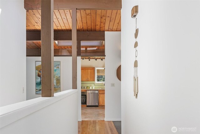 hall featuring beam ceiling, wooden ceiling, and light wood-type flooring