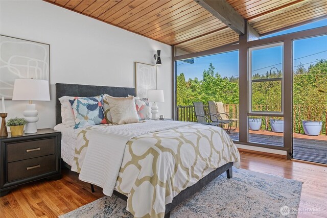 bedroom featuring wooden ceiling, wood finished floors, access to outside, and beamed ceiling