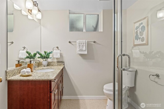 bathroom with baseboards, toilet, and vanity