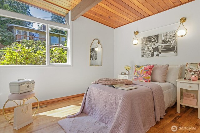 bedroom featuring wood ceiling, wood finished floors, and baseboards