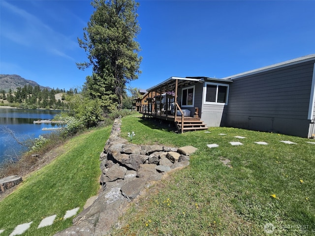 view of yard featuring a deck with water view