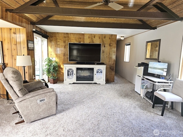 carpeted living area featuring wooden ceiling, lofted ceiling with beams, a ceiling fan, and wooden walls
