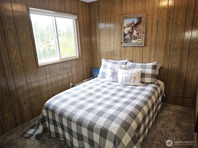 bedroom with wooden walls and carpet floors