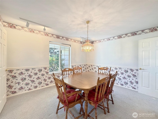 462 E Runnion, Sequim, WA 98382 - carpeted dining space featuring track lighting, an inviting chandelier, wallpapered walls, wainscoting, and baseboards
