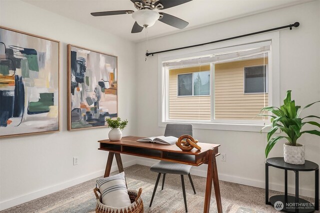 office area featuring baseboards, ceiling fan, and carpet