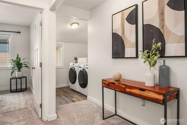 clothes washing area with carpet floors, laundry area, baseboards, and washer and clothes dryer