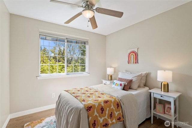 bedroom with baseboards, ceiling fan, and wood finished floors