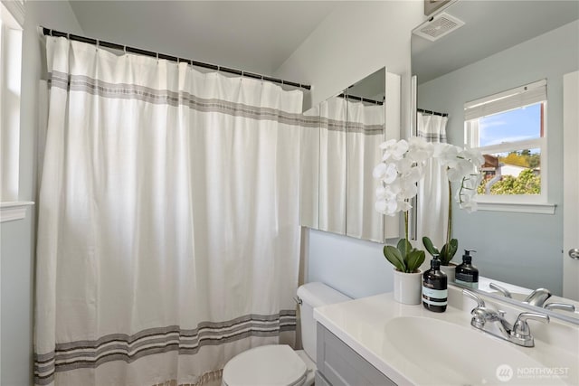 bathroom featuring toilet, visible vents, and vanity