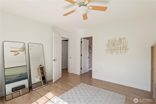 bedroom featuring baseboards, ceiling fan, and wood finished floors