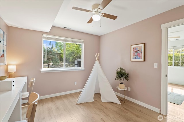 recreation room featuring light wood-style floors, baseboards, and visible vents