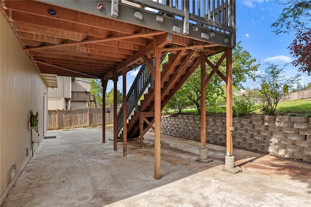 view of patio featuring stairs and fence