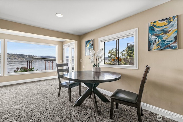 carpeted dining space featuring baseboards, french doors, and recessed lighting