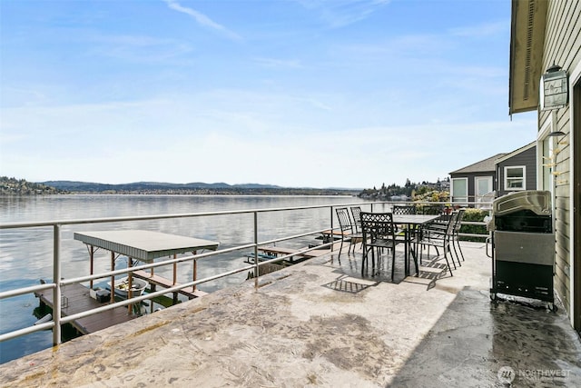 view of patio with a boat dock, area for grilling, and a water view