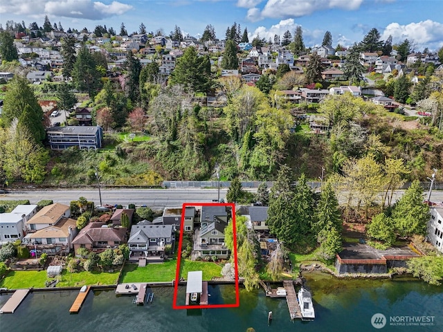 birds eye view of property with a residential view and a water view