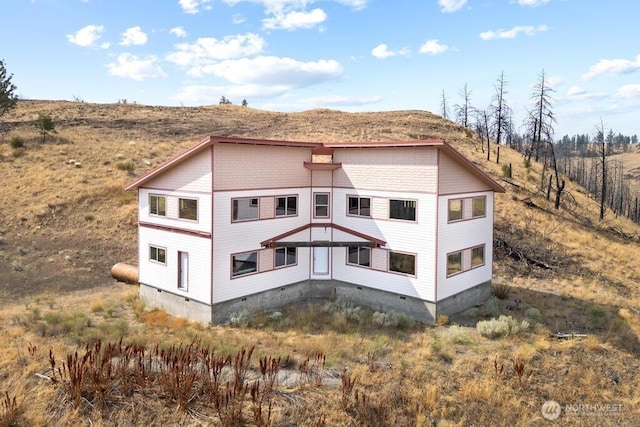 rear view of house with crawl space