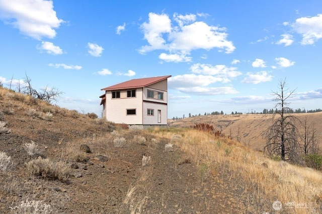 rear view of property with metal roof