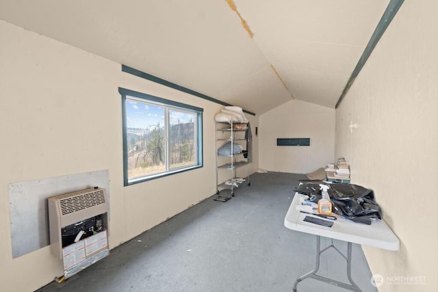interior space featuring vaulted ceiling and heating unit