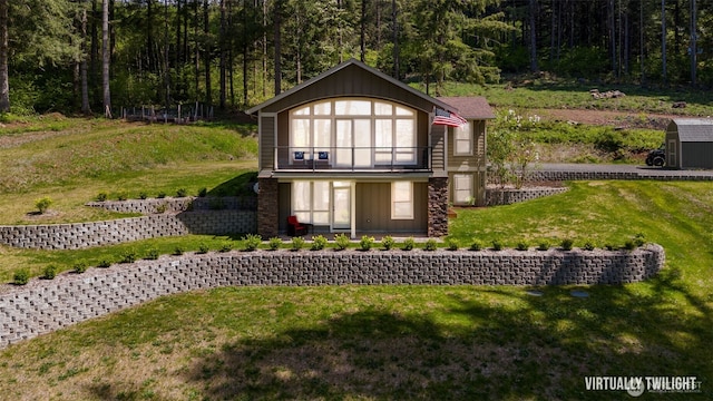 27406 NE 65th St, Camas, WA 98607 - view of front facade with a balcony, a front yard, a forest view, and board and batten siding