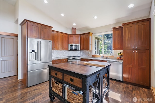 27406 NE 65th St, Camas, WA 98607 - kitchen with appliances with stainless steel finishes, backsplash, a sink, lofted ceiling, and dark wood-style flooring