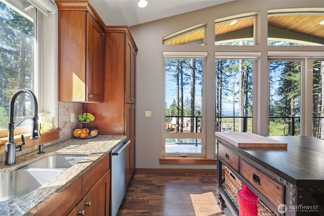 27406 NE 65th St, Camas, WA 98607 - kitchen with a sink, dark wood-style flooring, brown cabinets, vaulted ceiling, and dishwasher