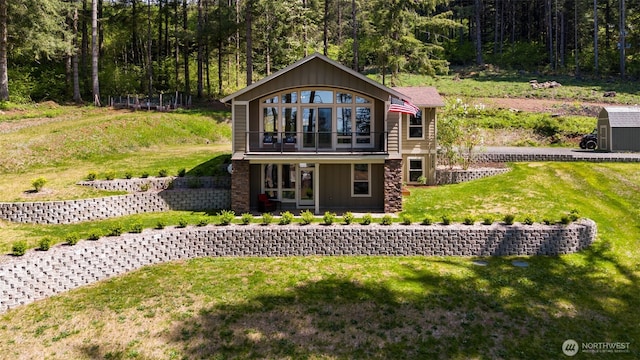 27406 NE 65th St, Camas, WA 98607 - view of front of property featuring a front lawn, a wooded view, a balcony, and board and batten siding