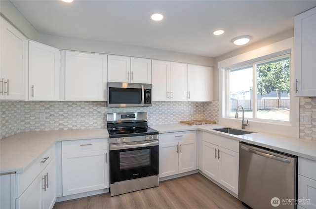 303 Alder Ln N, Pacific, WA 98047 - kitchen with white cabinets, a sink, and appliances with stainless steel finishes