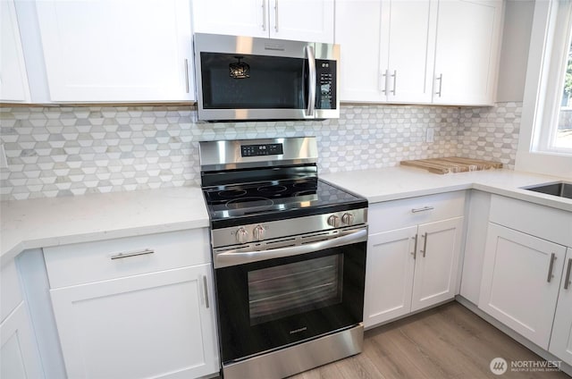 303 Alder Ln N, Pacific, WA 98047 - kitchen with stainless steel appliances and white cabinetry