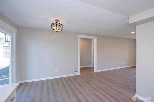 303 Alder Ln N, Pacific, WA 98047 - unfurnished room featuring light wood finished floors, visible vents, and baseboards