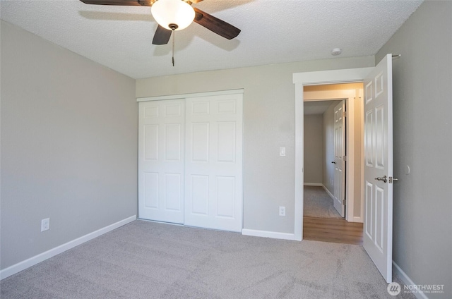 303 Alder Ln N, Pacific, WA 98047 - unfurnished bedroom featuring ceiling fan, a textured ceiling, a closet, carpet flooring, and baseboards