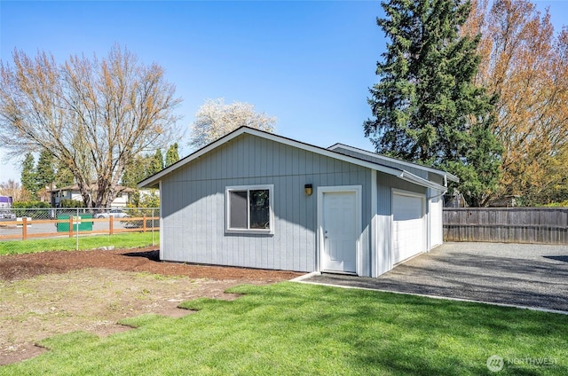 303 Alder Ln N, Pacific, WA 98047 - view of outdoor structure with driveway, fence, and an outbuilding