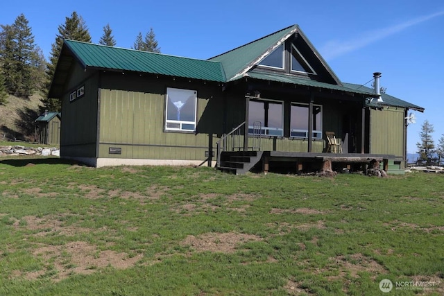 view of front of house with metal roof and a front yard