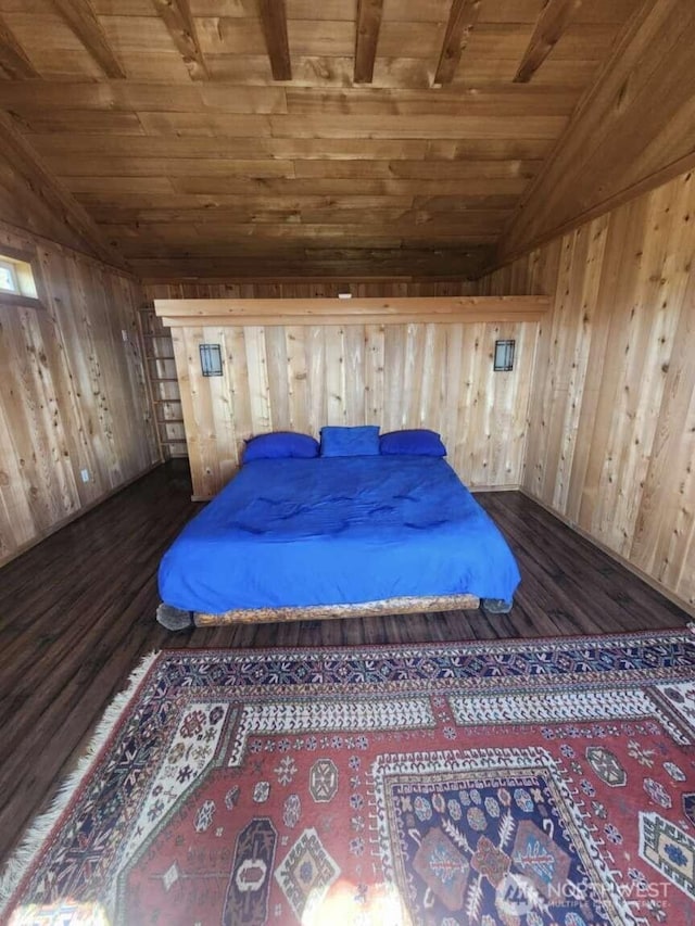 bedroom with dark wood finished floors, wooden walls, vaulted ceiling, and wooden ceiling