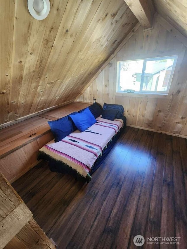 bedroom with lofted ceiling, hardwood / wood-style flooring, and wood walls