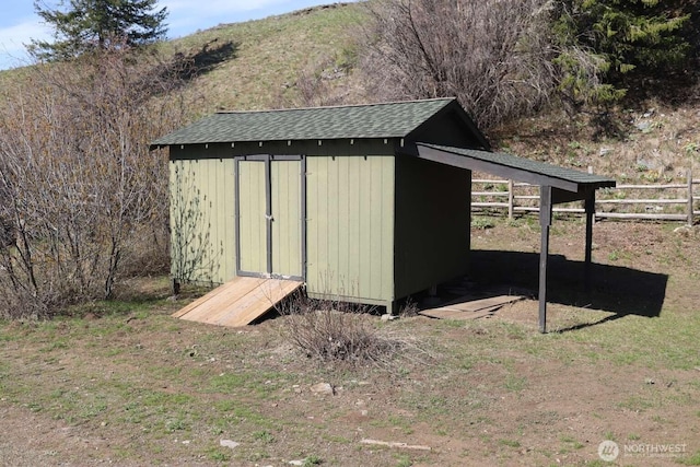 view of shed with fence