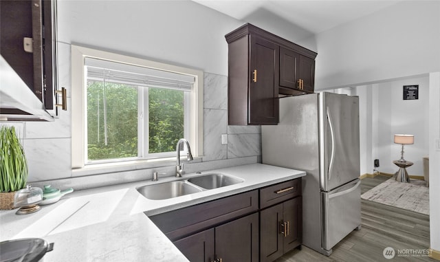 4204 Letitia Ave S, Seattle, WA 98118 - kitchen featuring freestanding refrigerator, a sink, dark brown cabinetry, decorative backsplash, and light countertops
