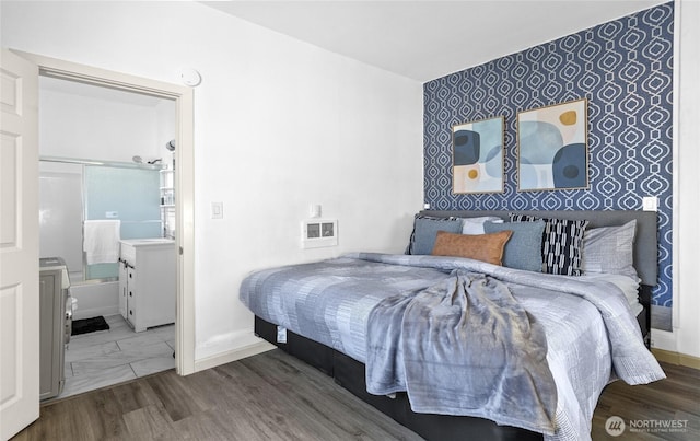 4204 Letitia Ave S, Seattle, WA 98118 - bedroom with ensuite bath, an accent wall, and baseboards