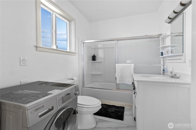 4204 Letitia Ave S, Seattle, WA 98118 - bathroom with toilet, marble finish floor, washer / dryer, vanity, and combined bath / shower with glass door