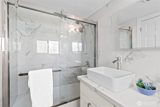 4204 Letitia Ave S, Seattle, WA 98118 - bathroom with vanity, tile walls, and combined bath / shower with glass door