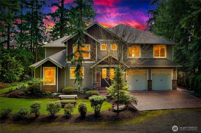 craftsman inspired home with a yard, roof with shingles, driveway, and an attached garage