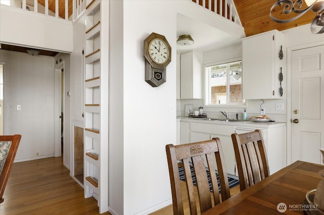 2963 Saratoga Rd, Langley, WA 98260 - kitchen with a sink, white cabinetry, light wood-style floors, and light countertops