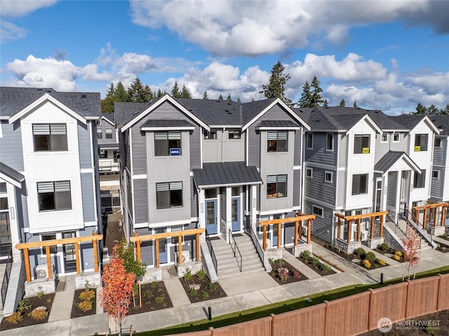 13362 NE 143rd Ct Unit 53, Woodinville, WA 98072 - view of front of property featuring a standing seam roof, a residential view, fence private yard, and metal roof